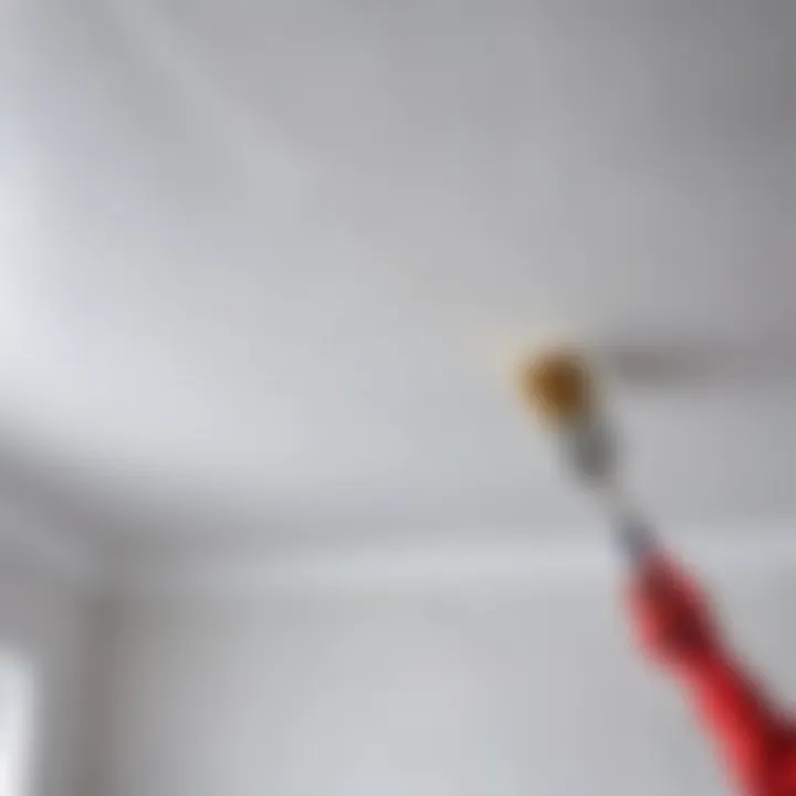 Close-up of a brush applying paint on a ceiling