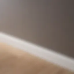 Detailed view of a plastic skirting board installed against a wall