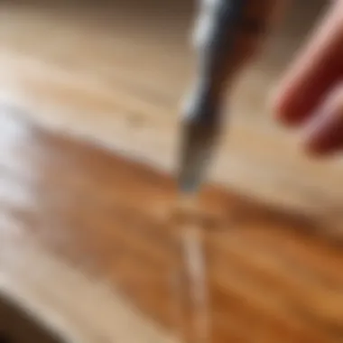 Close-up of liquid nails application on a wooden surface