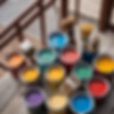 Close-up of paint cans and brushes with various colors suitable for balcony woodwork.