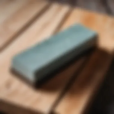 A sharpening stone placed on a wooden surface